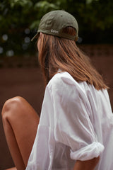 A model wearing Cove. caps in colour green