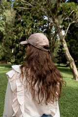 The detail of a new Cove. cap in pale pink colour