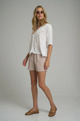 model wears check shorts