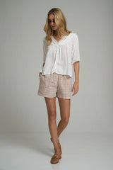 model wears cotton check shorts in relaxed fit