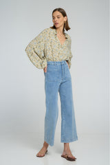 Wide-leg stretch denim jeans in pale blue with front patch pockets.