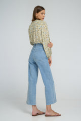 Pale blue jeans styled casually with block-heeled sandals.