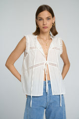 Open front lace blouse in white, worn casual.