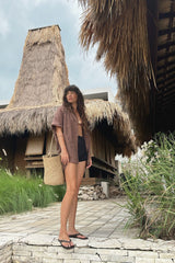 Model wears rope basket bag in sumba