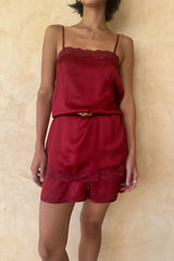 Modwel wears satin mini dress styled with shorts and belted at the waist for a stylish set.