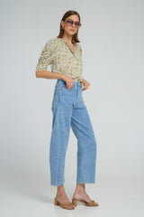 A model wearing light blue modern denim jeans and floral top