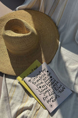 poolside photo of notebook in yellow and beige