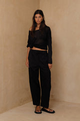 Frontview of the black Coconut Pants highlighting the relaxed straight-leg fit and breathable cotton fabric.