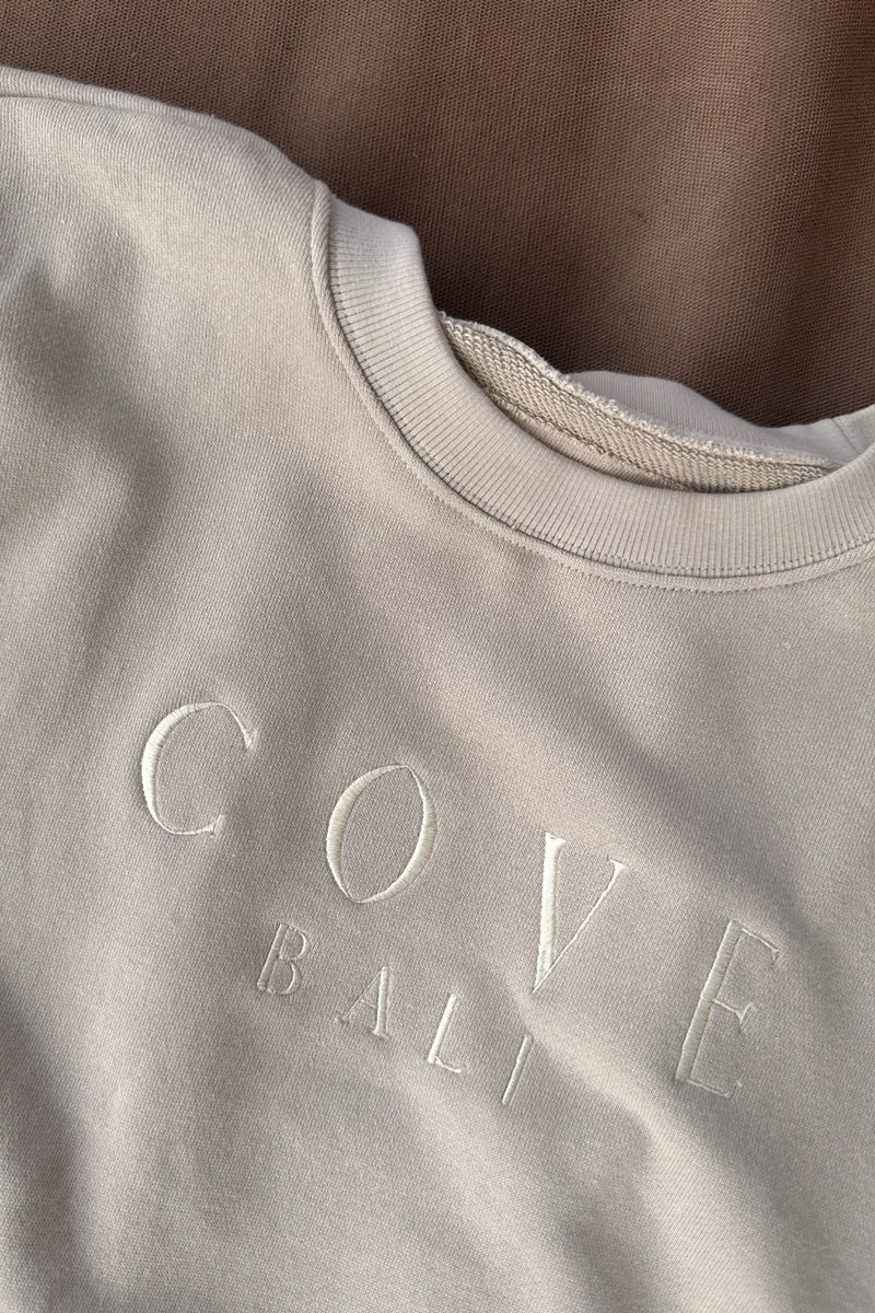 close up look of cove. island essentials bali sweater in sand color