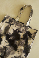 Stylish tie-dye cotton tote bag in brown shades, worn with casual outfit.