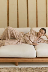 Model wear relaxed stripe pants styled as a set