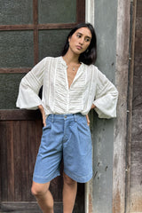 Relaxed ivory top styled with denim