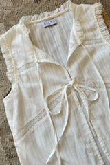 A flatlay photo of sleeveless lace top by LILYA