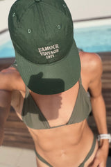 Model wears green baseball cap by LILYA