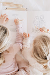 girls colouring in abcs book