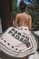 a woman wearing pink green padang padang sarong