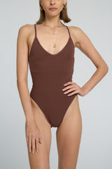 model wears a one piece swimsuit
