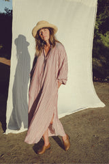Woman wearing the Toulouse Dress in Amalfi Stripe, a relaxed cotton rayon maxi dress with a button front and Nehru collar.