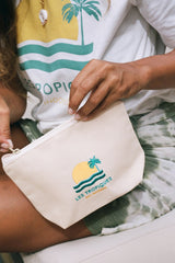 a woman holding a white pouch by We Like Bali