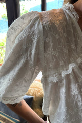 Relaxed white blouse with lace detailing