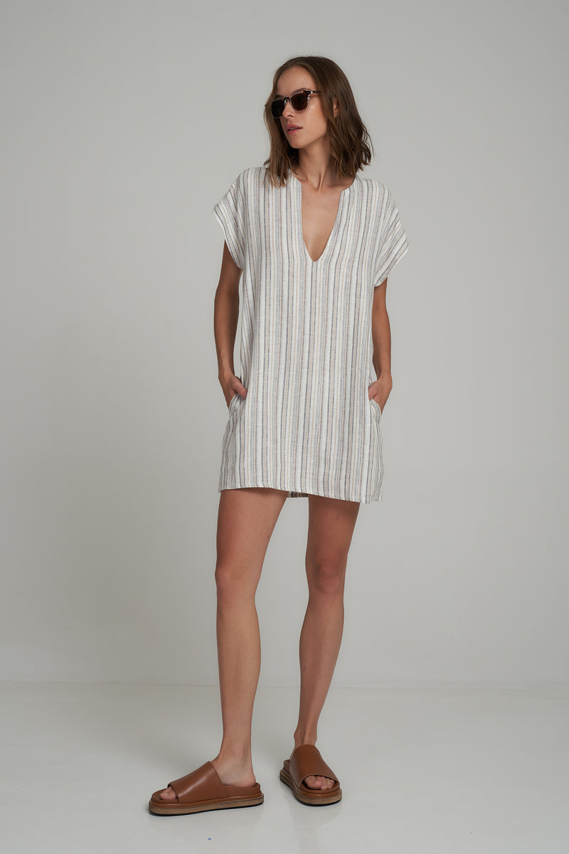 A stripe linen mini dress with pockets on a girl