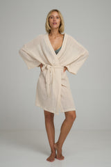 A woman wearing a natural cotton mesh casual robe by Lilya