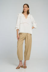 White cotton top that lightweight and with lace styled casually with relaxed utility pants.
