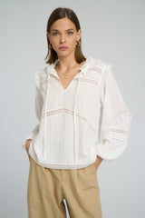 white lace top featuring tie neck design and relaxed long sleeve fit.