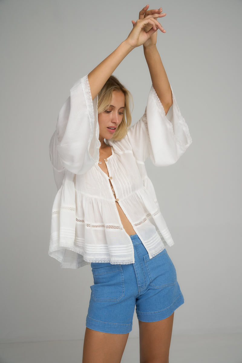 A model wearing a white summer cotton top