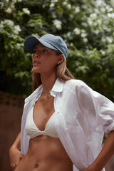 A model wearing Cove. caps in colour blue perfect for everyday caps