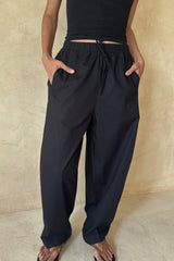Front view of the Coconut Pants in Black featuring lightweight Meridian cotton and an ankle-length silhouette.