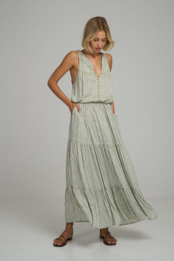 A model wearing a blue floral maxi dress by LILYA