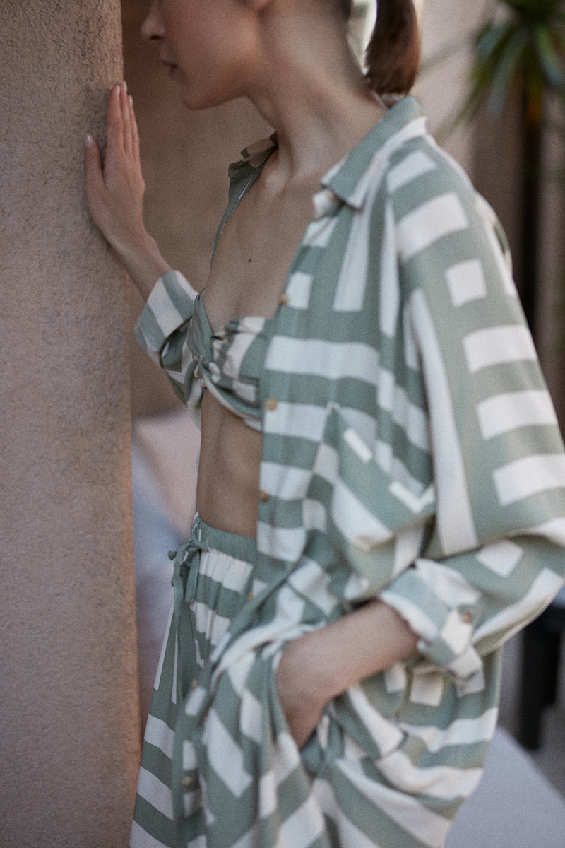 A model wearing a green casual shirt dress