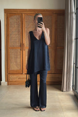 Girl wearing the Essentia Pants in Navy with a satin top, showing the high-rise waist and fluid drape.