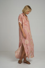 A woman wearing a pink floral maxi shirt dress in Australia by Lilya