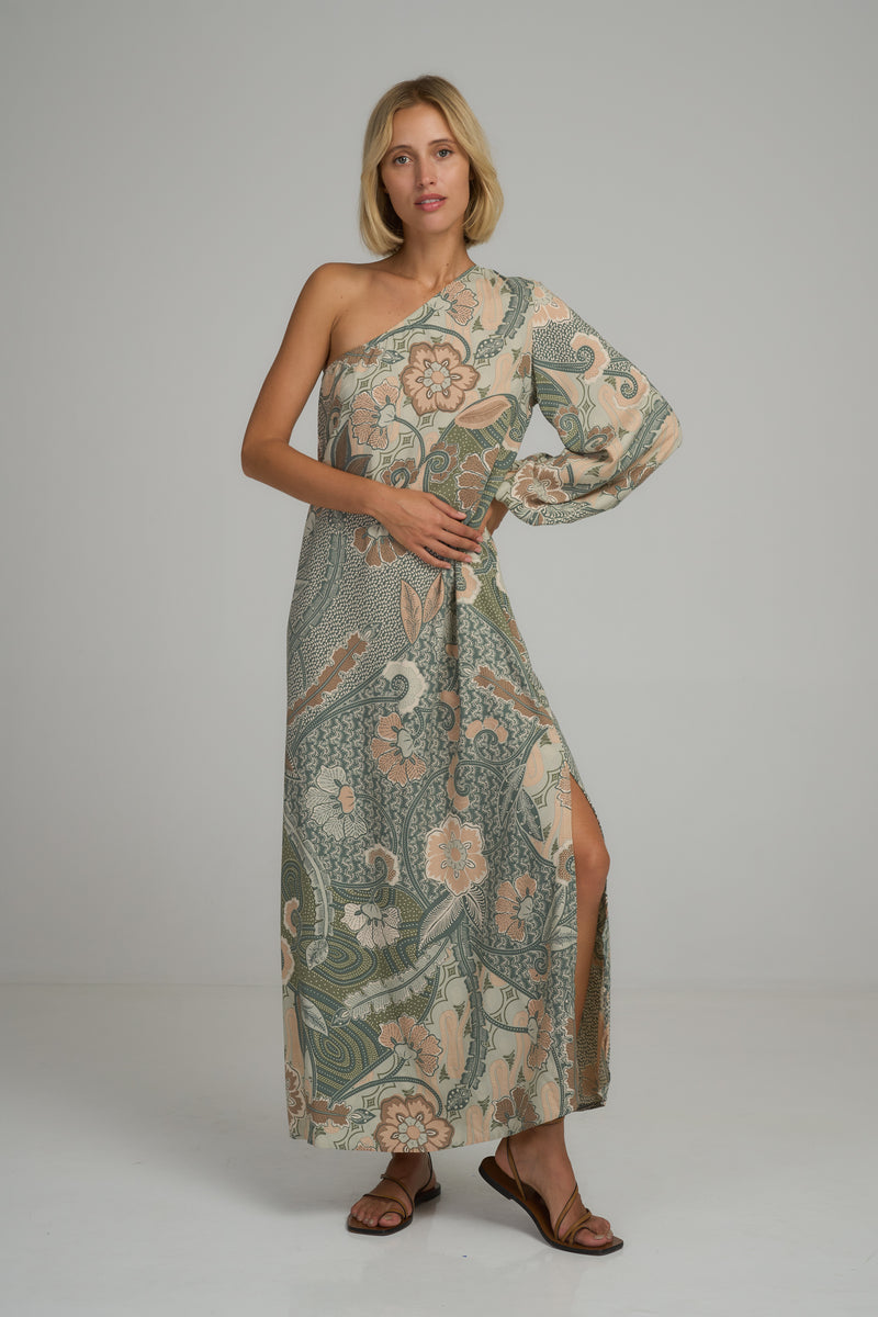 A model wearing a green batik print maxi dress by Lilya 