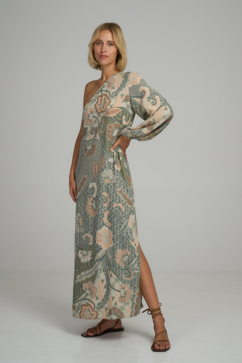 A model wearing a green batik print maxi summer dress by Lilya