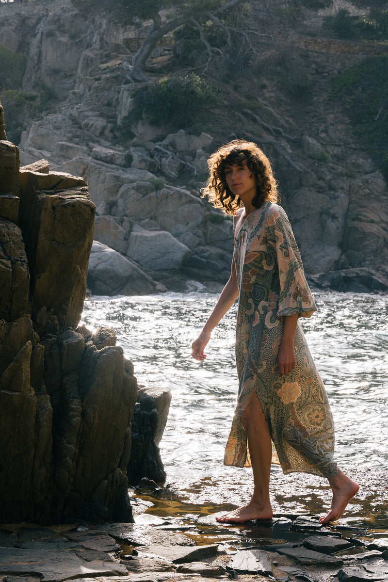 A model wearing a green batik print maxi dress in Australia By Lilya