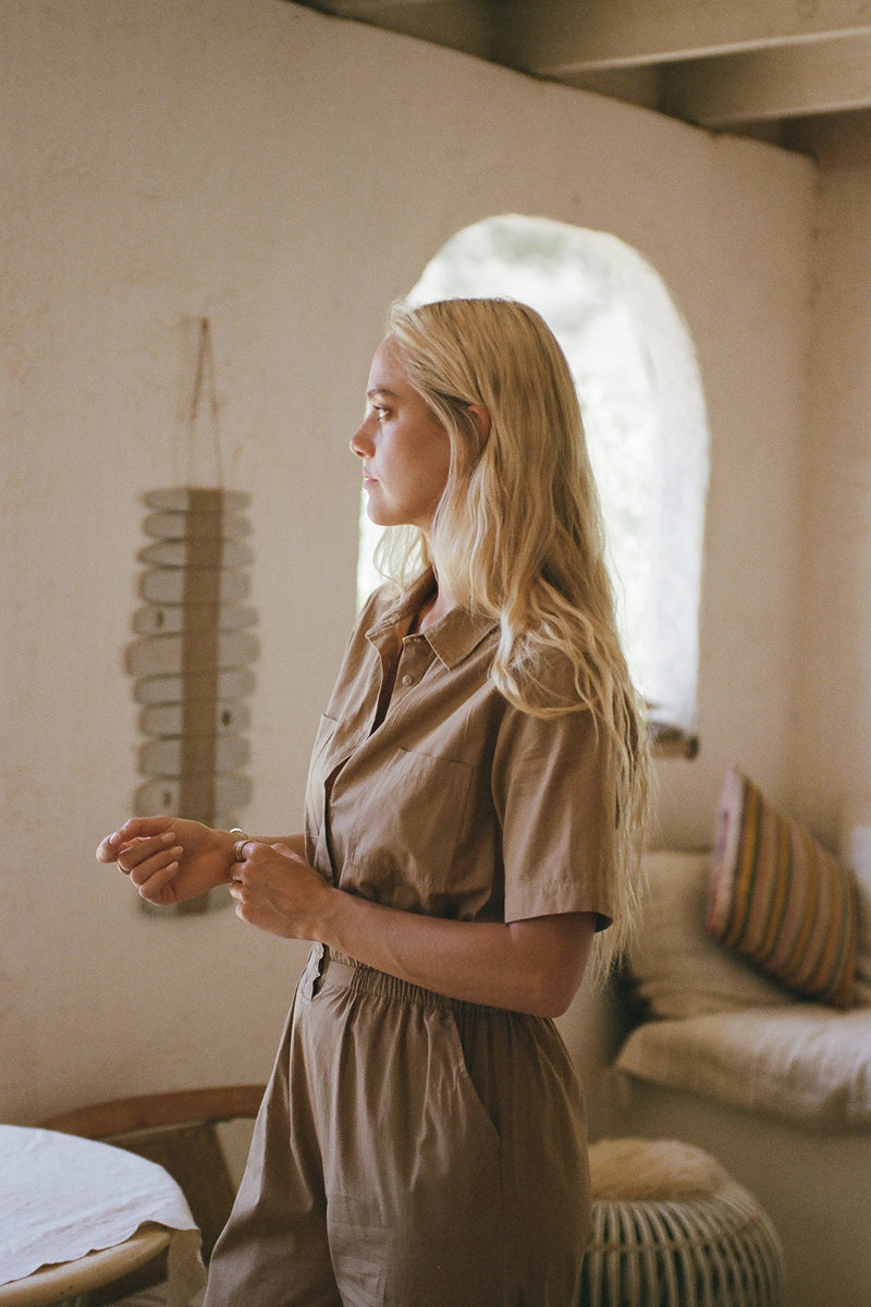 A woman wearing a natural cotton jumpsuit for summer