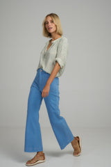 A woman wearing light blue high waisted cropped jeans