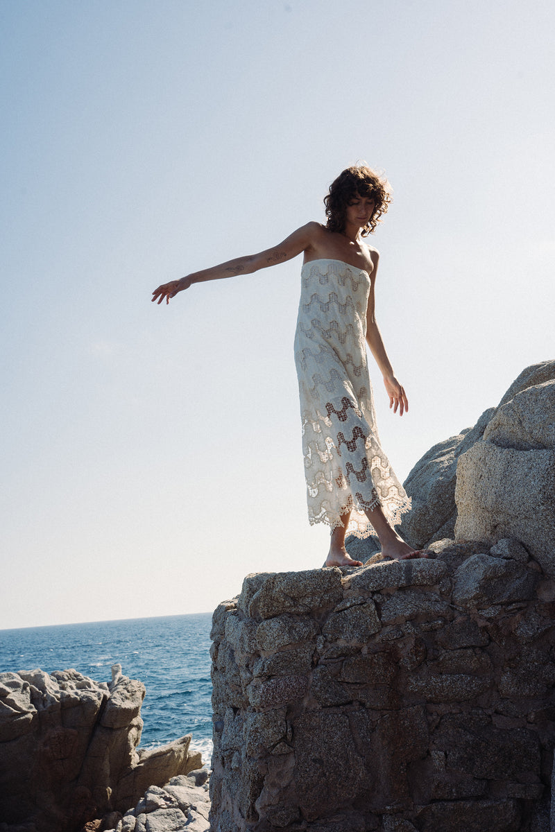 A model wearing Norfolk Strapless lace Dress in ivory by lilya