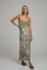 A model wearing a green batik print maxi dress by Lilya
