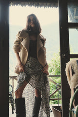 Model wears floral maxi skirt with jacket by LILYA