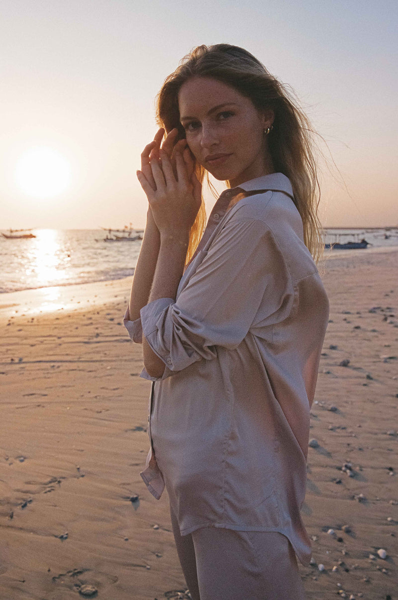 A Model Wearing the Roshi Silky Shirt in Oyster by LILYA