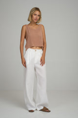 A model wearing white linen dress pants in Australia by Lilya