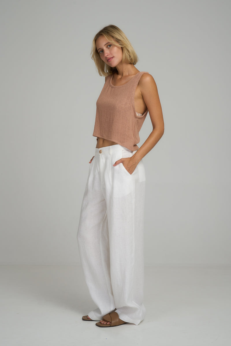 A model wearing white wide leg linen pants by LILYA 