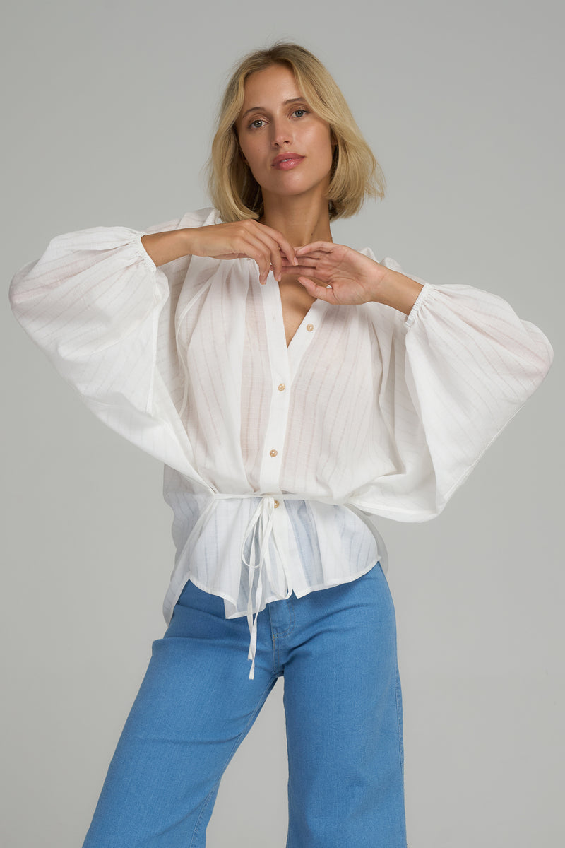 A model wearing a white cotton blouse in Australia