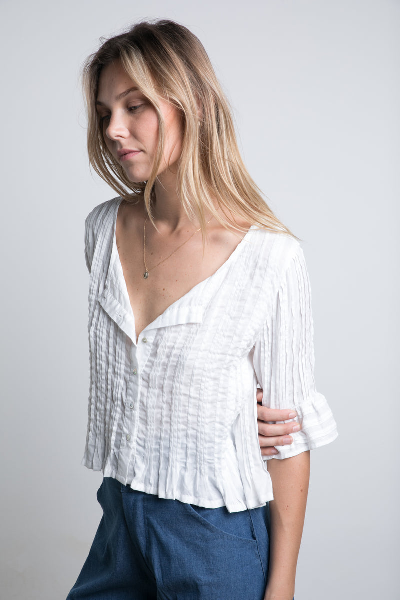 A model wearing the sonora in ivory colour for summer blouse by Lilya 