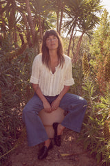 Olivia wearing the Sonora Top with Lou Lou Jeans in her garden in California. 