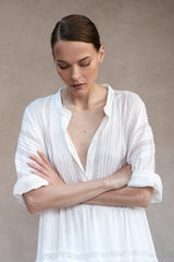 A model wearing a white cotton mini summer dress